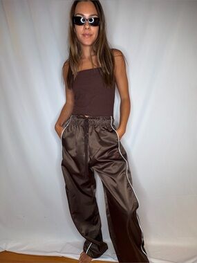 The open product brown Track Joggers with White Piping